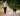 a man walking a dog down a dirt road